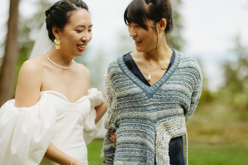 Couple sharing a tender moment during an outdoor wedding celebration in natural lighting.
