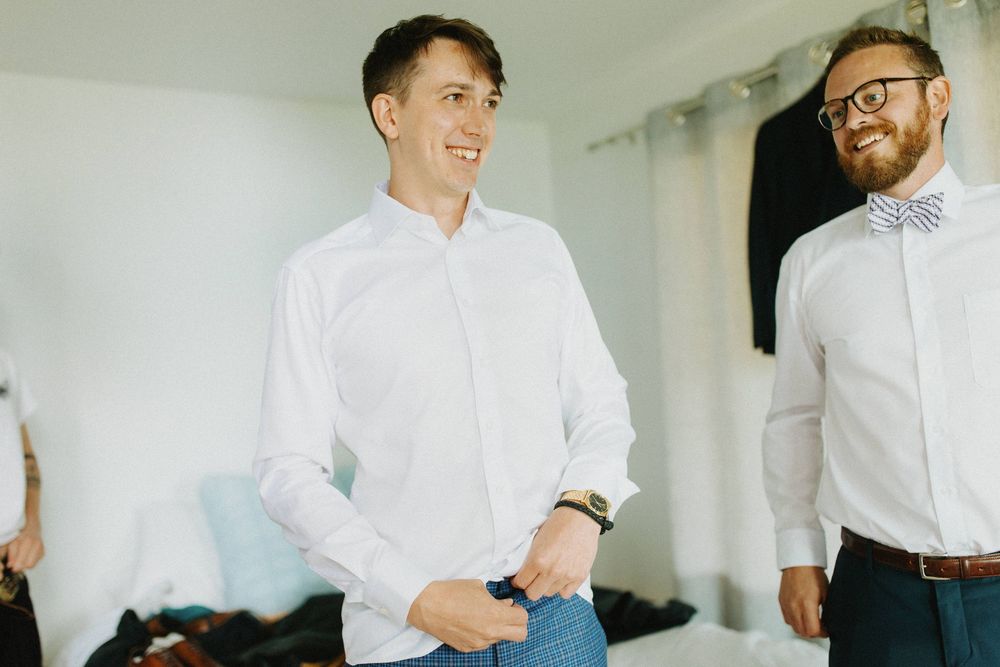 Group wearing crisp white dress shirts preparing for formal event.