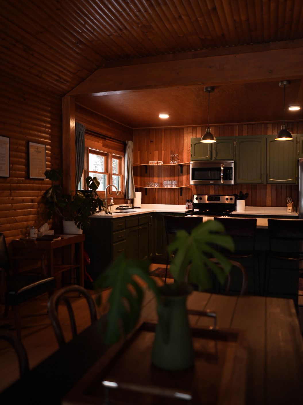Dark wooden cabin interior with warm lighting and modern furnishings.