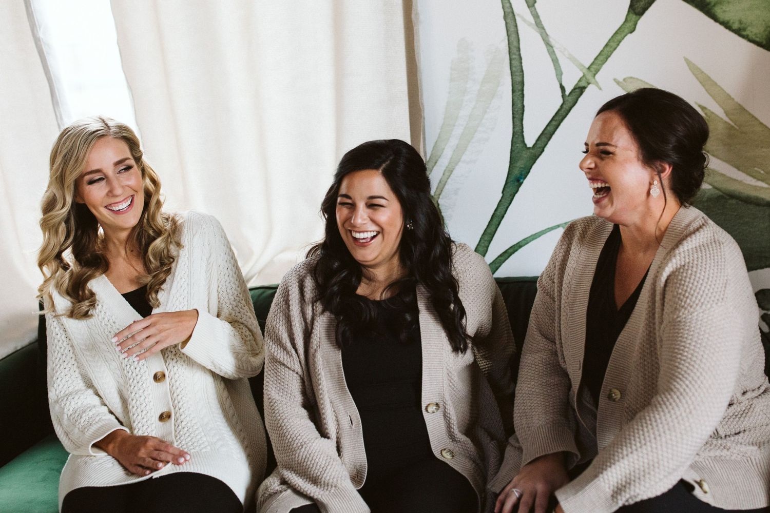 Casual meetup with friends sharing laughs in a sunlit room with exposed brick walls.