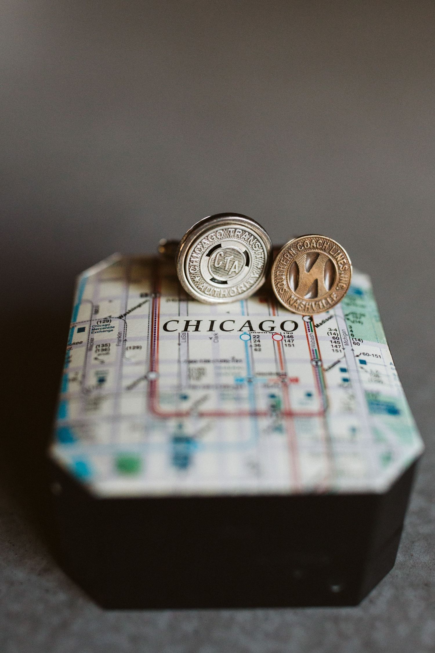 Chicago transit map with silver coins arranged on top showing urban transportation routes.