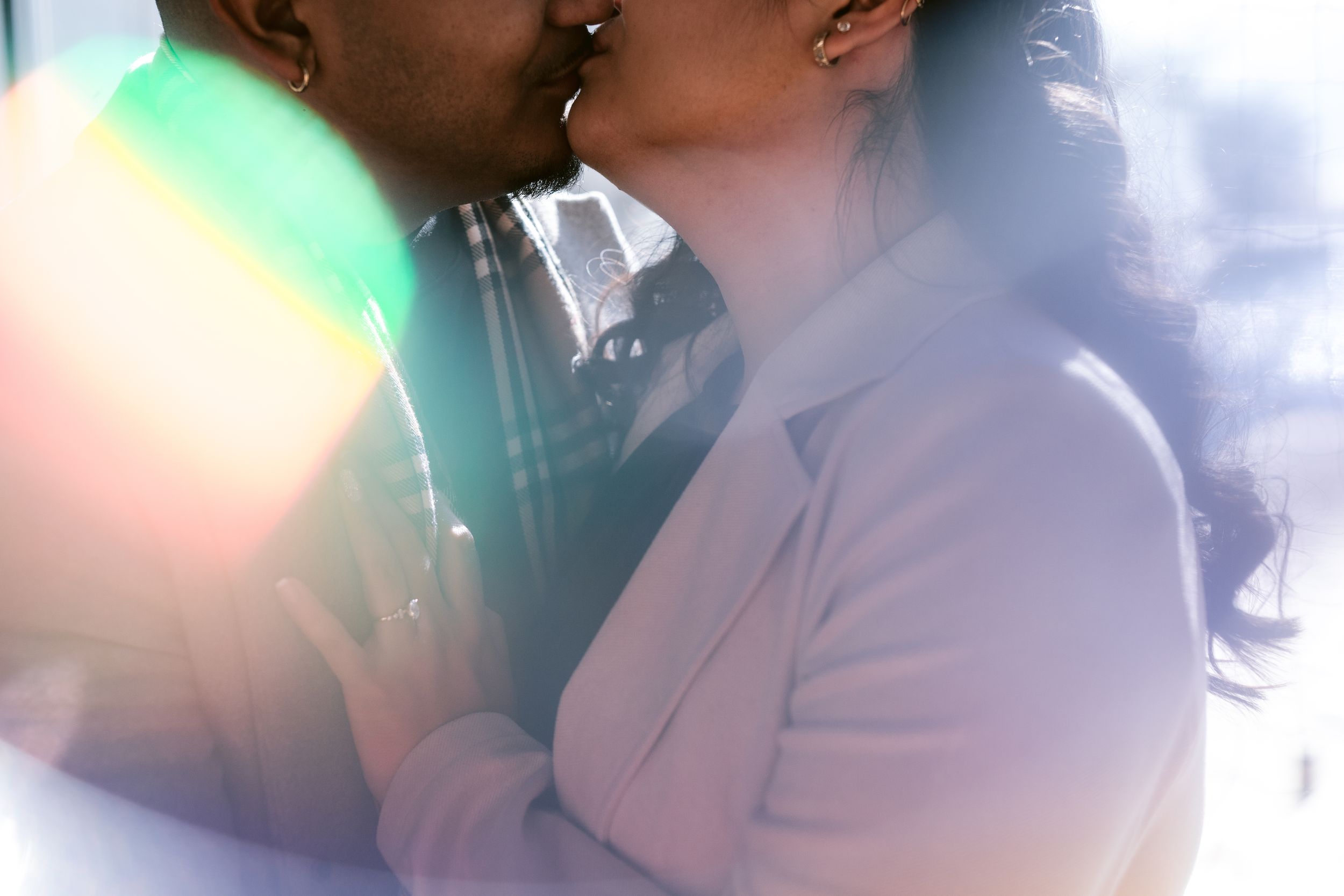 Artistic backlit photograph with sunlight flare and soft romantic atmosphere.