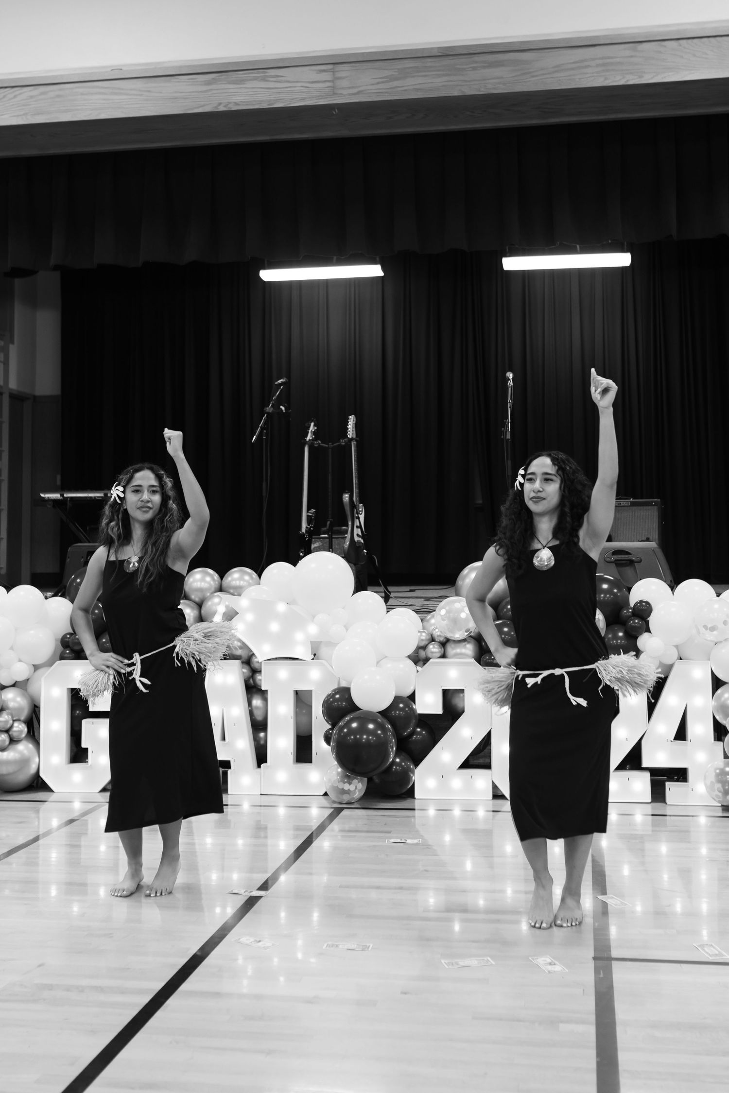 sisters performing a graceful hula dance at their senior graduation party