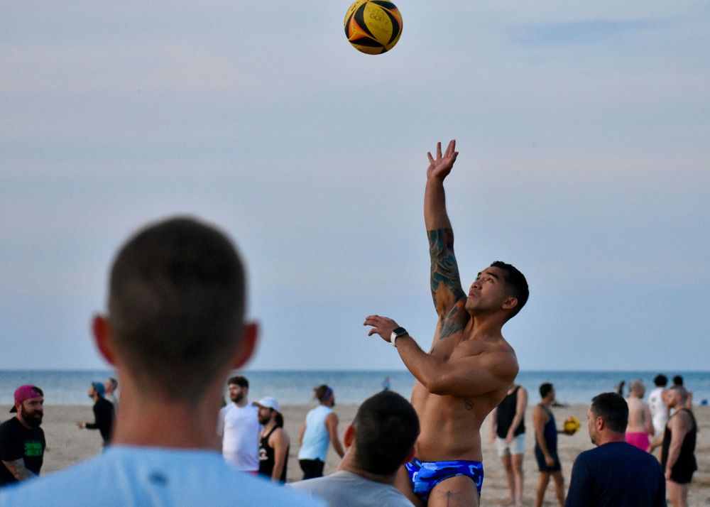 A CMSA volleyball player returns a ball over the net in a game at Montrose Beach in Chicago