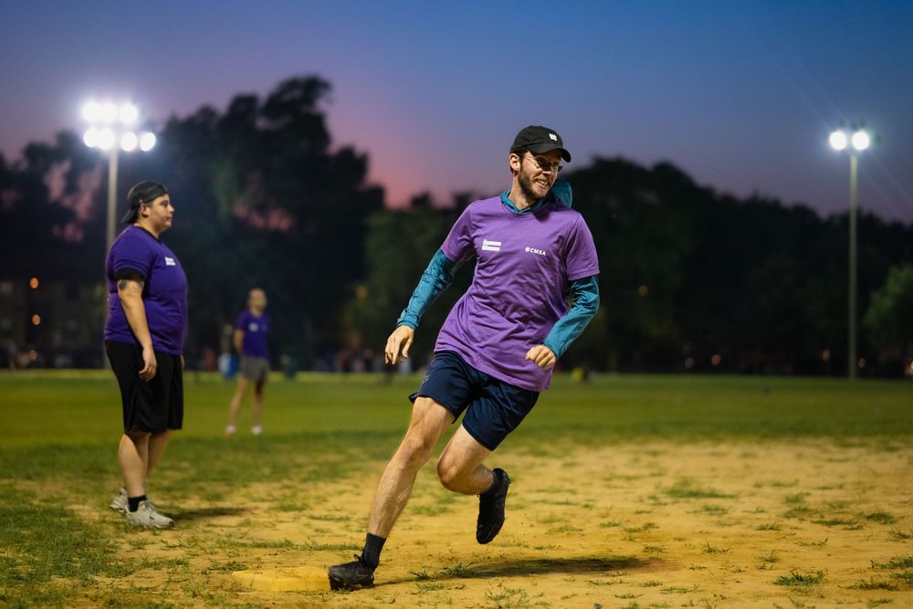 A kickball athlete rounds third base