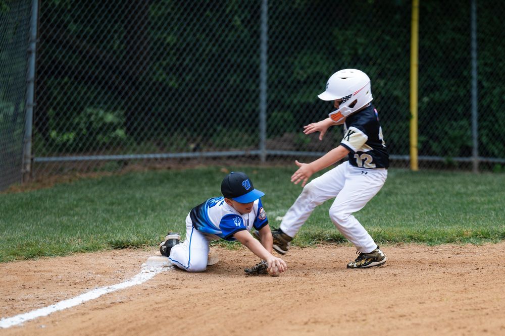 Baseball players sliding into bases during multiple action shots on dirt infield.