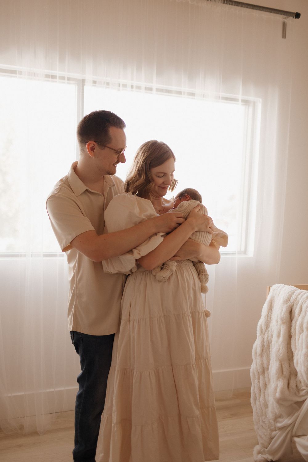 Five-panel sequence showing tender family moments in a minimalist white room setting.