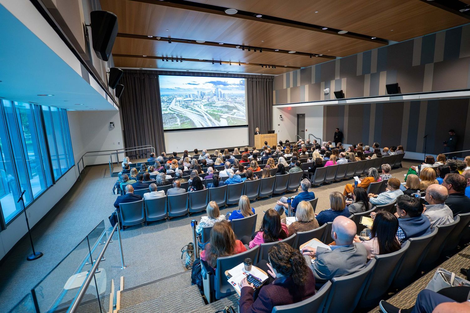 Students attending a corporate leadership event in a university auditorium — photographed by a Houston event photographer