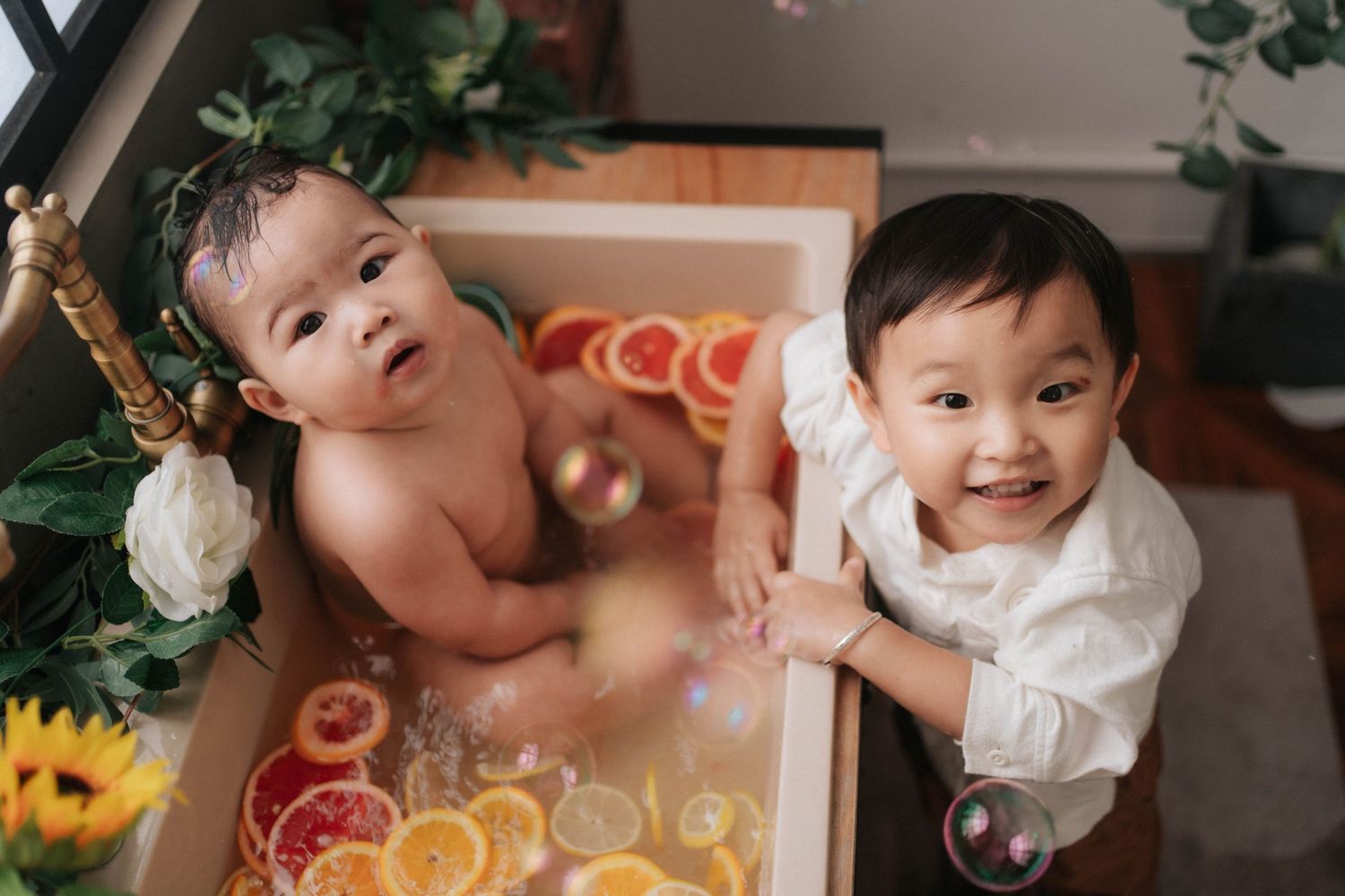 A series of candid photos showing a baby's first birthday celebration with cake smash moments and festive decorations.