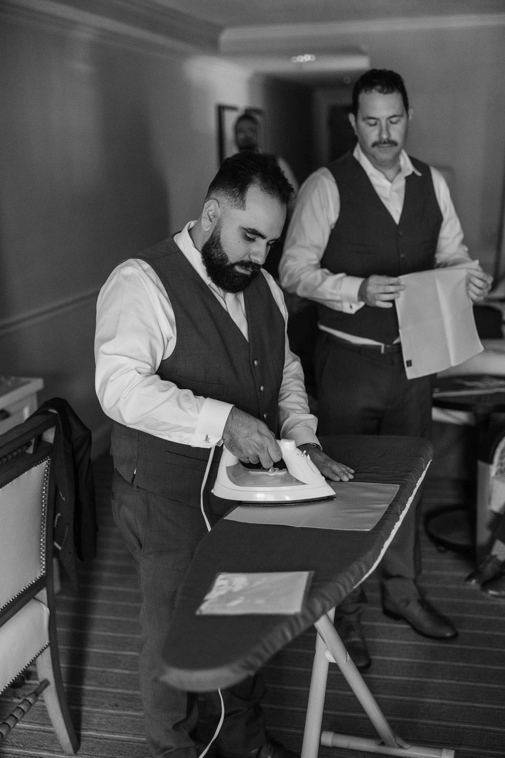 A black and white photo sequence shows a person in formal attire writing at a desk in an office setting.