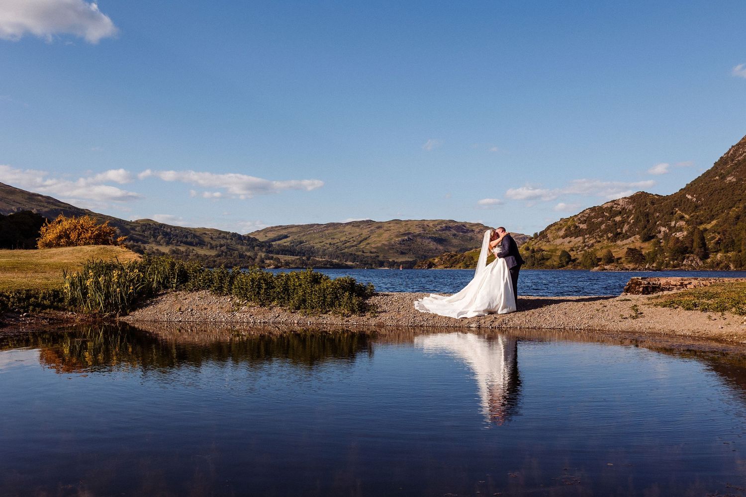 Panoramic sequence of a wedding couple posing along a tranquil mountain lake with scenic mountain backdrop.
