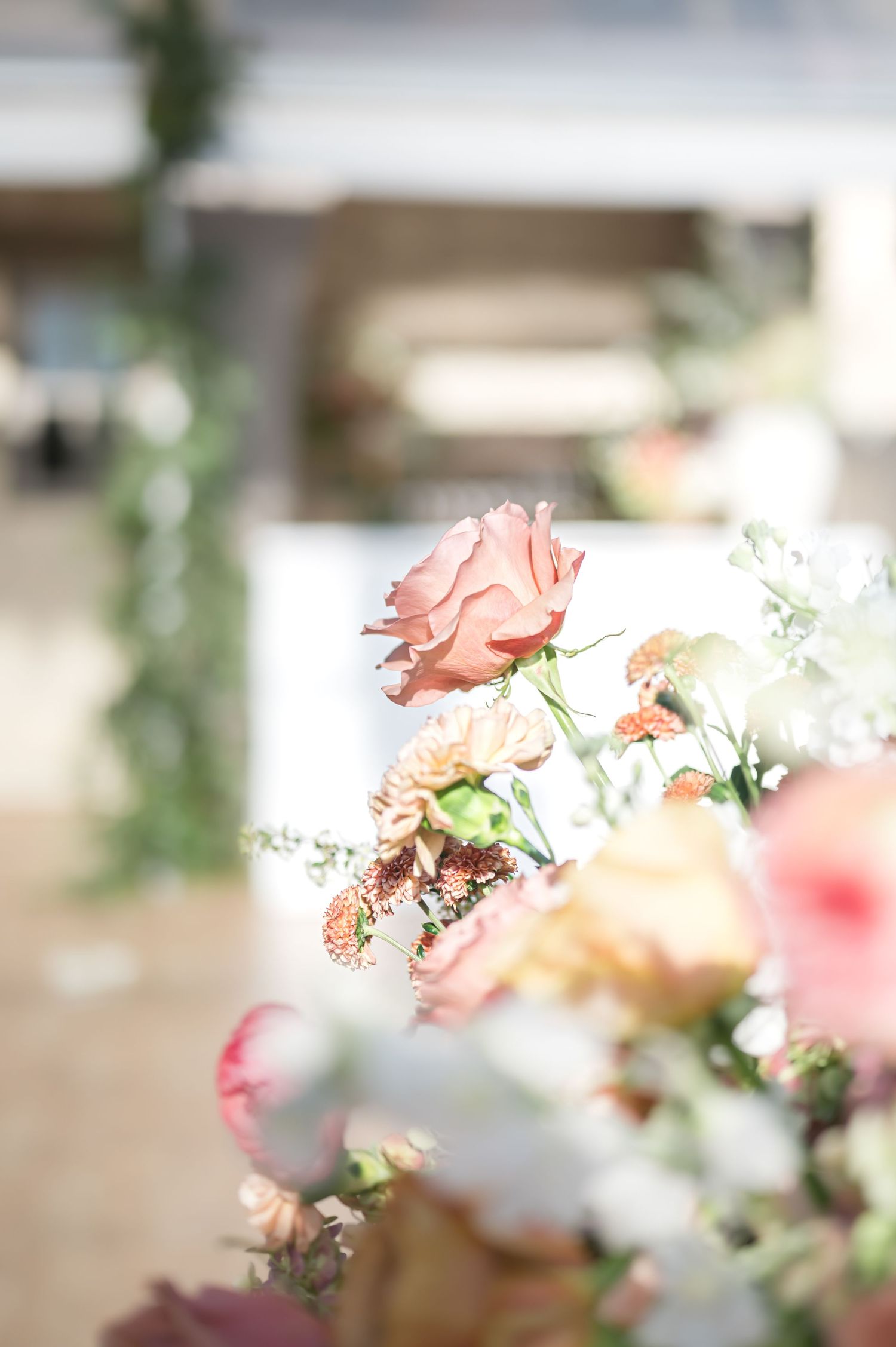 Delicate pink and white flowers with soft bokeh background create a romantic floral arrangement.