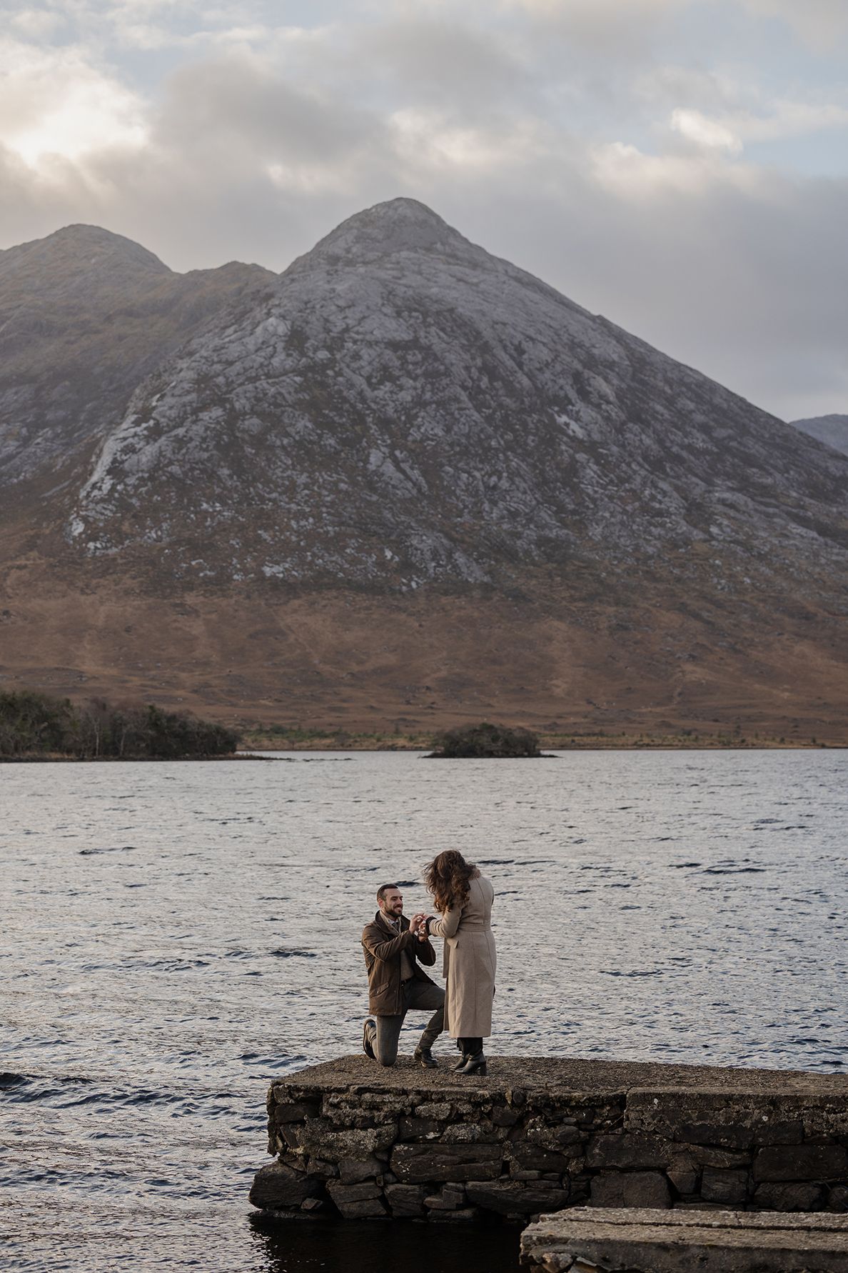 Couple embracing at Lough Inagh Valley during intimate sunset proposal