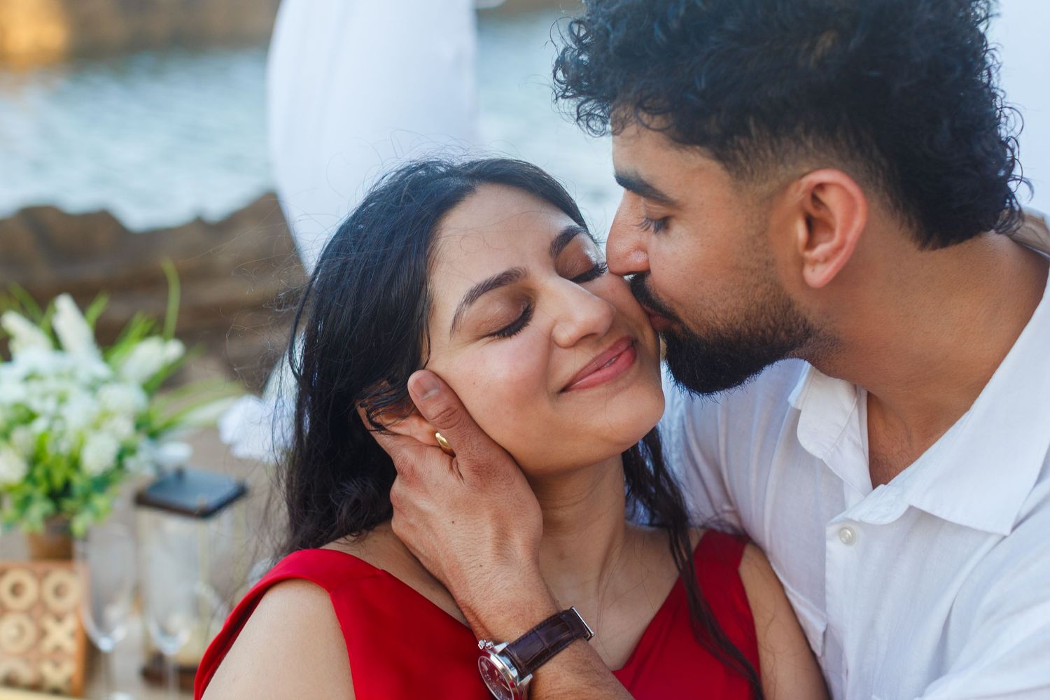 Couples portrait. Proposal and engagement session. Man and woman on the beach. Kiss on the cheek. Kikita Surf Beach, Dorado, Puerto Rico.