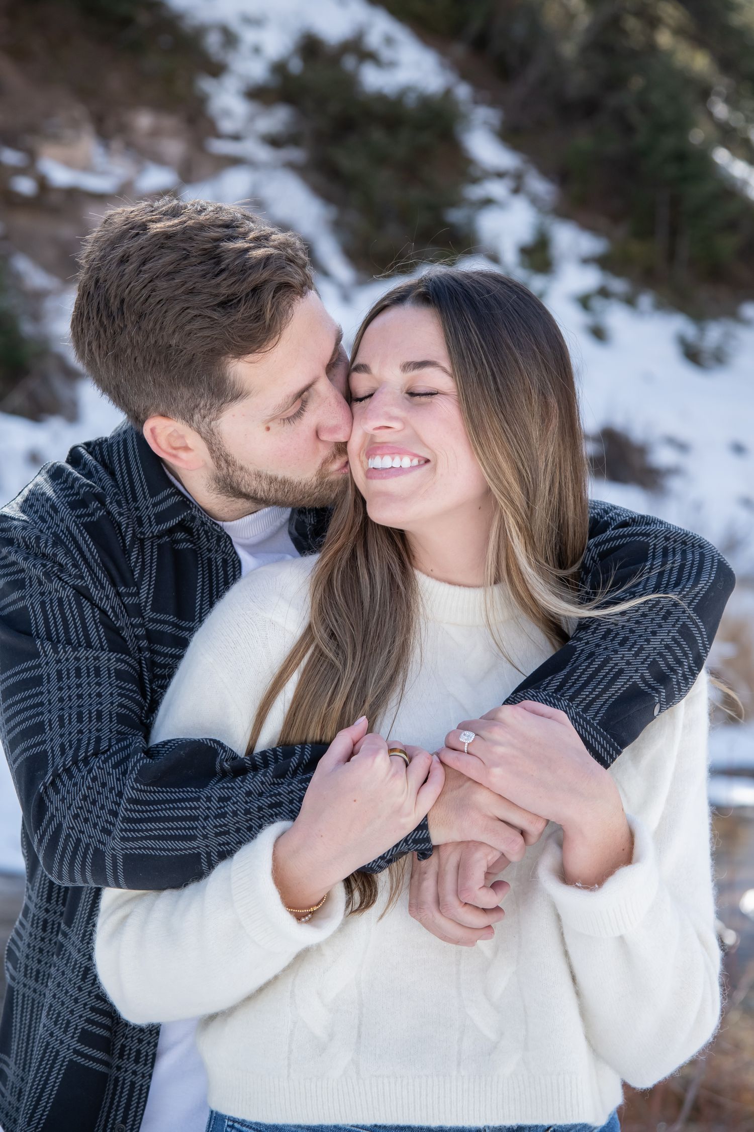 Romantic photo of a couple embracing during their winter engagement photo session in Vail Colorado