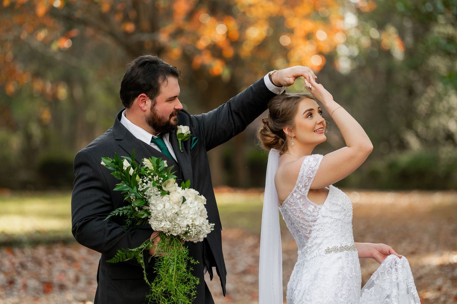A romantic wedding photo series captured in a forest with autumn foliage and golden light.
