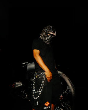 A series of dark artistic photographs showing hands with gloves holding a camera in dramatic lighting conditions.