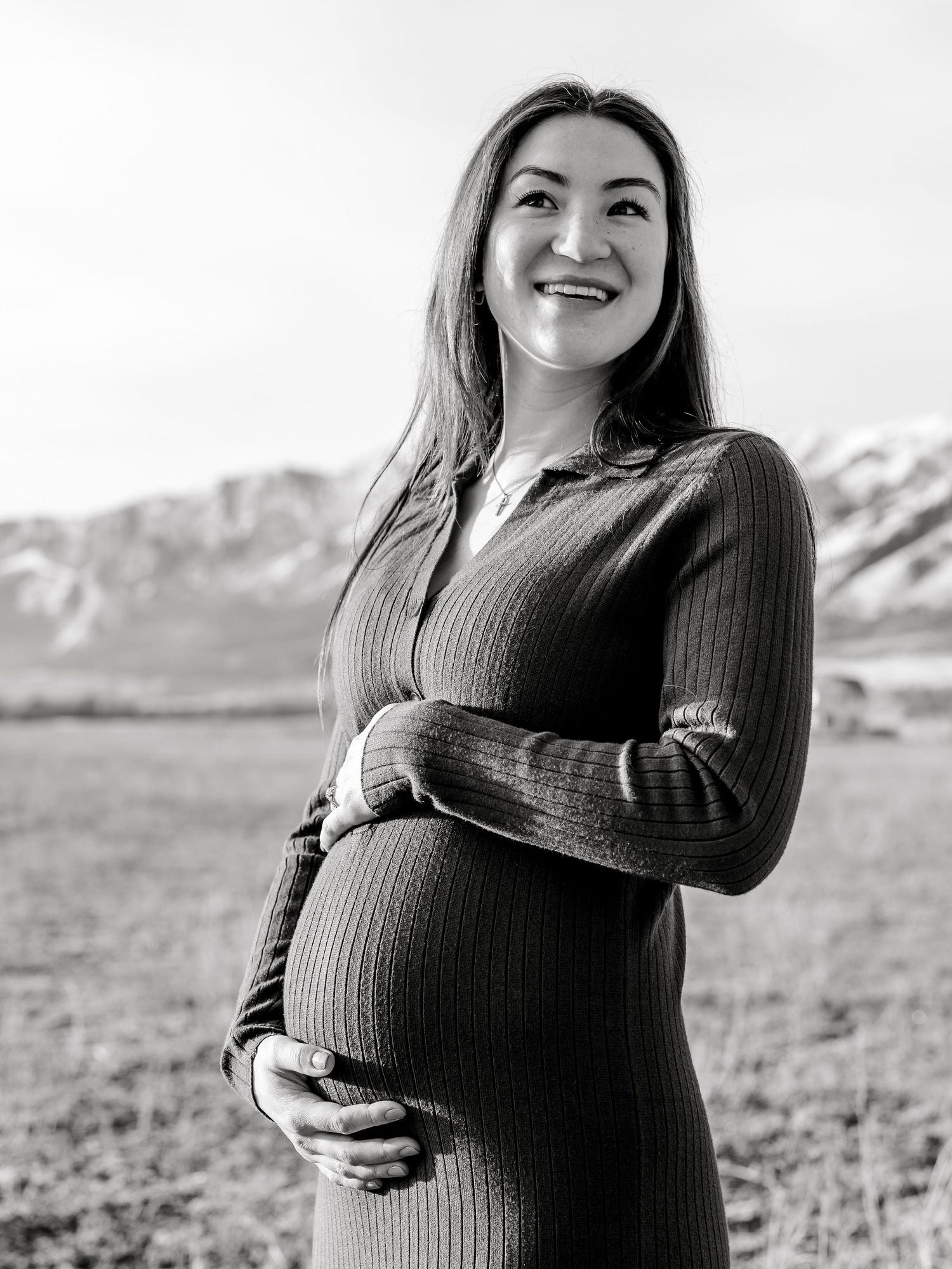 Black and white portrait of an expectant mother in a ribbed sweater dress. Utah Maternity Photos Maternity Photographer in Utah
