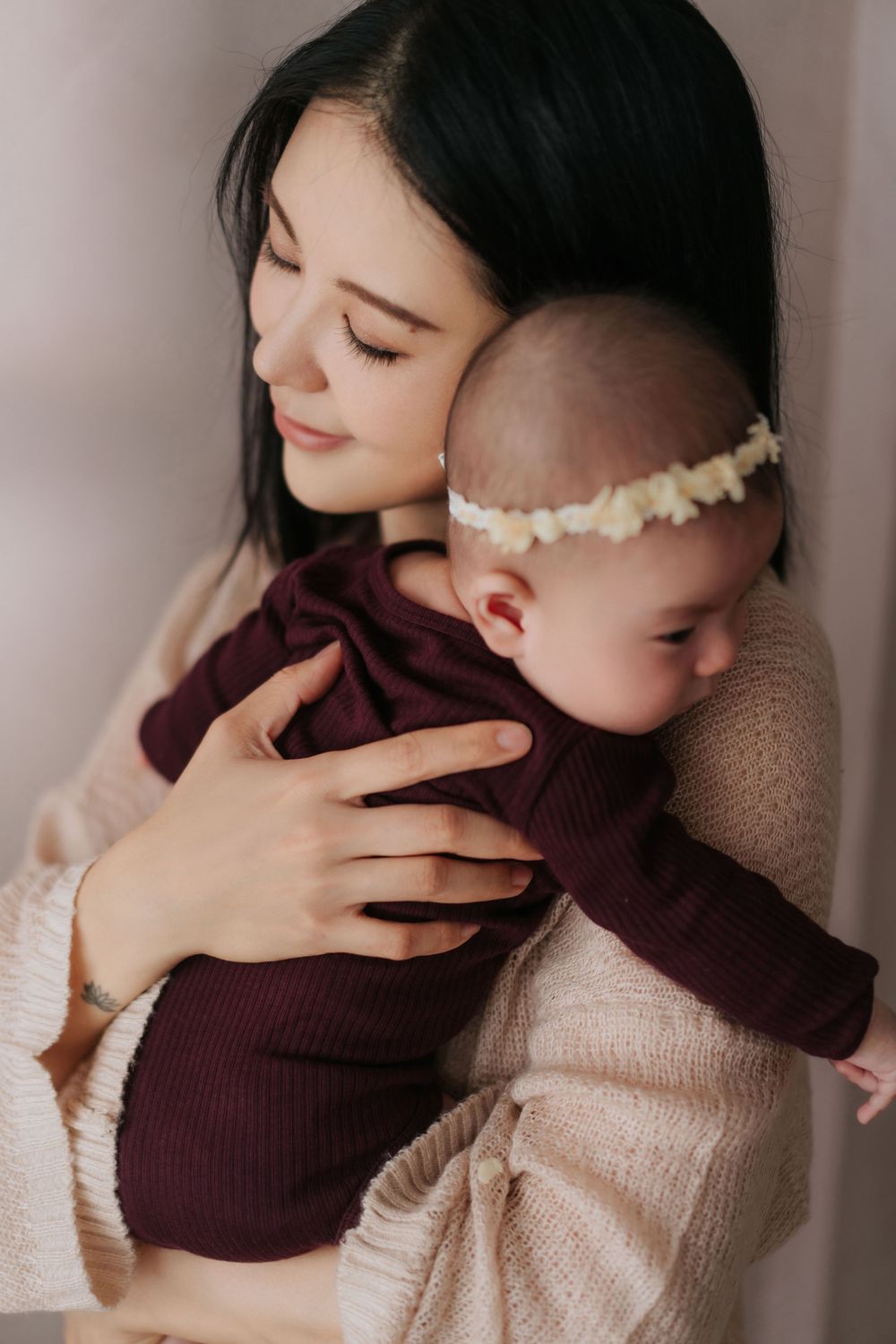 A tender embrace is shared between two people wearing burgundy and beige sweaters in a series of intimate photos.