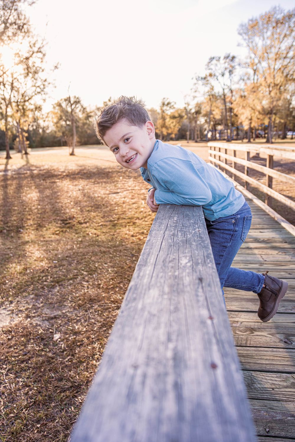 Series of photos showing playful poses along a wooden boardwalk in a park during golden autumn light.
