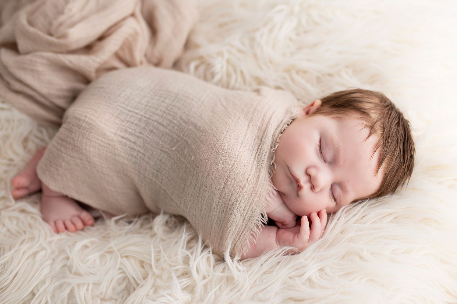 newborn baby in swaddled by little wonderland photography widnes cheshire