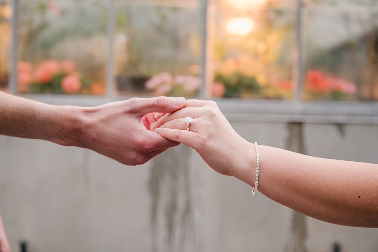 Close-up shots showing the progression of a marriage proposal as hands exchange an engagement ring.