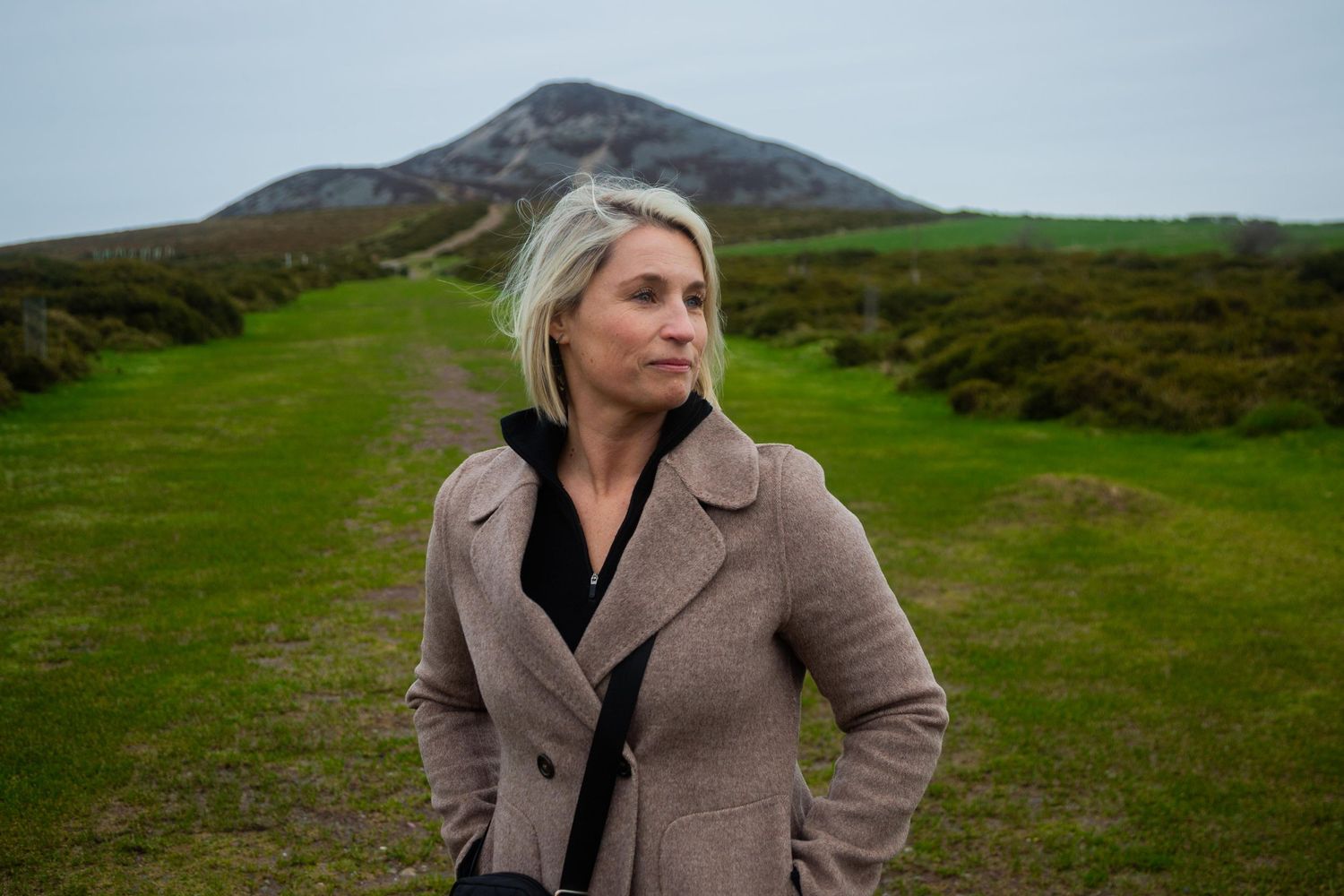 Single traveller posing against the backdrop of the Sugar loaf during a private tour of county Wicklow