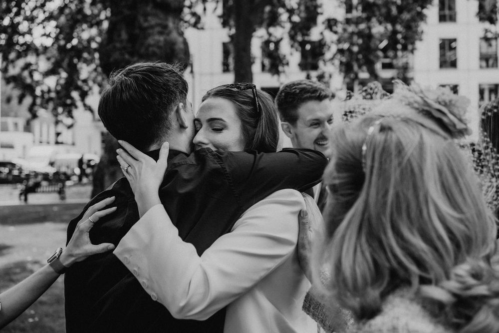 A black and white collage of people dancing and celebrating at what appears to be a wedding reception.