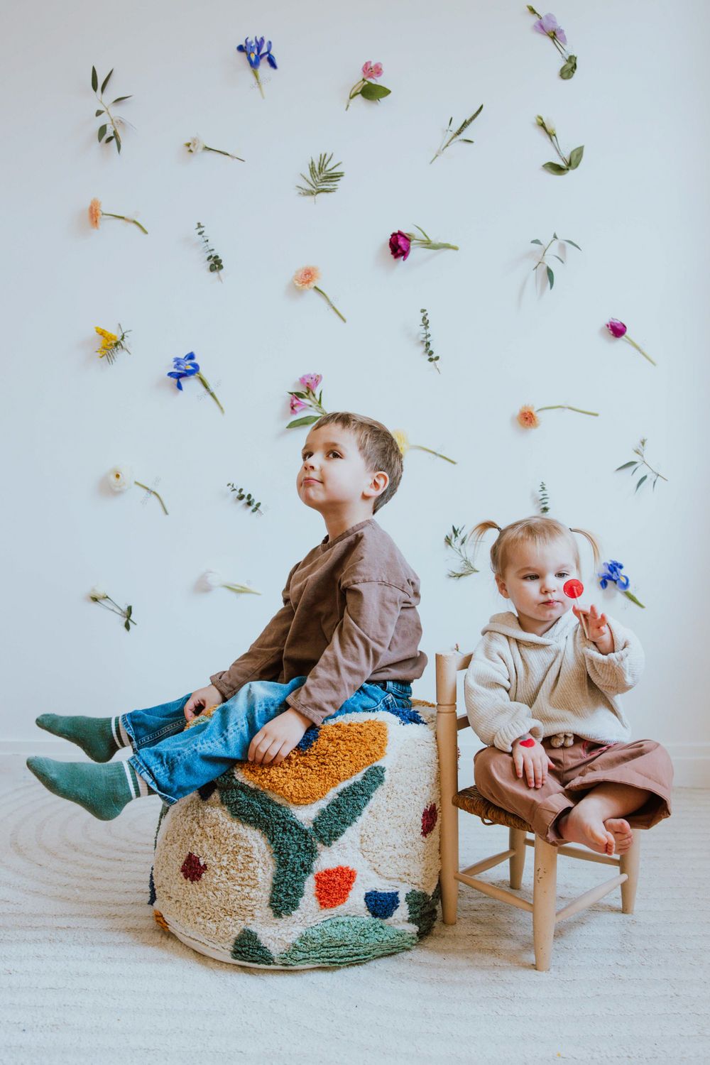 A series of playful images showing children on a rocking toy with whimsical floating flowers and petals in the background.