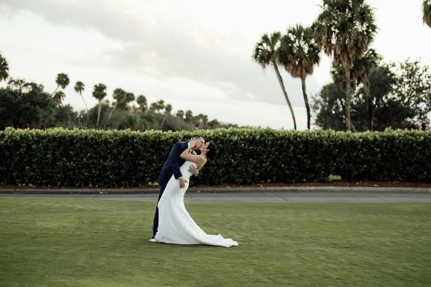 An elegant winter wedding reception features romantic white floral decor and candlelight in a grand venue setting.