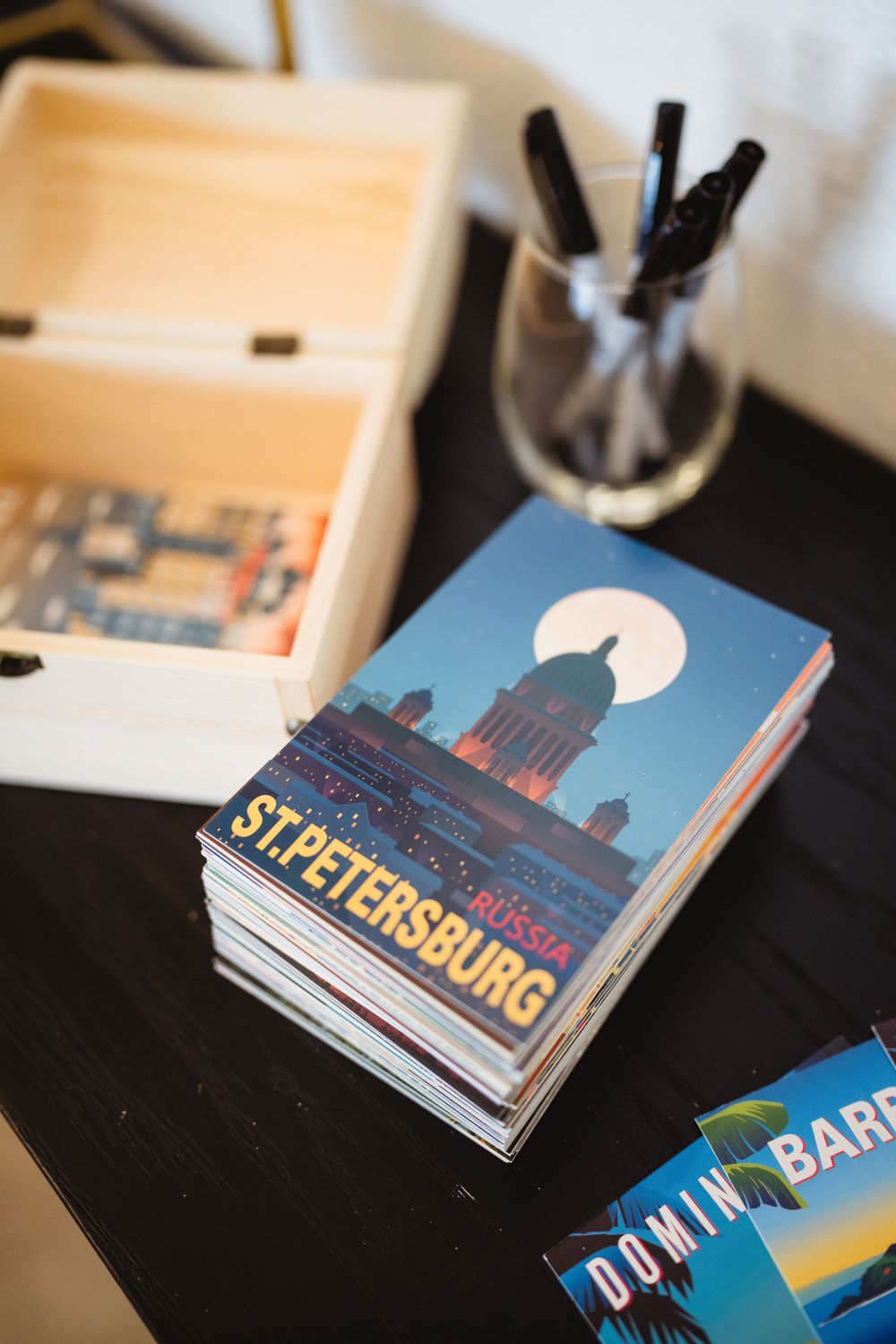 Travel guidebooks featuring St. Petersburg and other destinations displayed on dark surface.