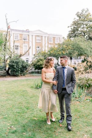 Married couple walking hand-in-hand through London streets after Islington Town Hall wedding, by romantic Nottingham wedding photographer.