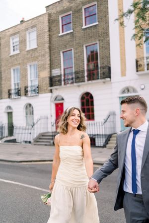 Bride and groom laughing on vibrant London street after Islington Town Hall elopement by a Nottingham & East Midlands wedding photographer.