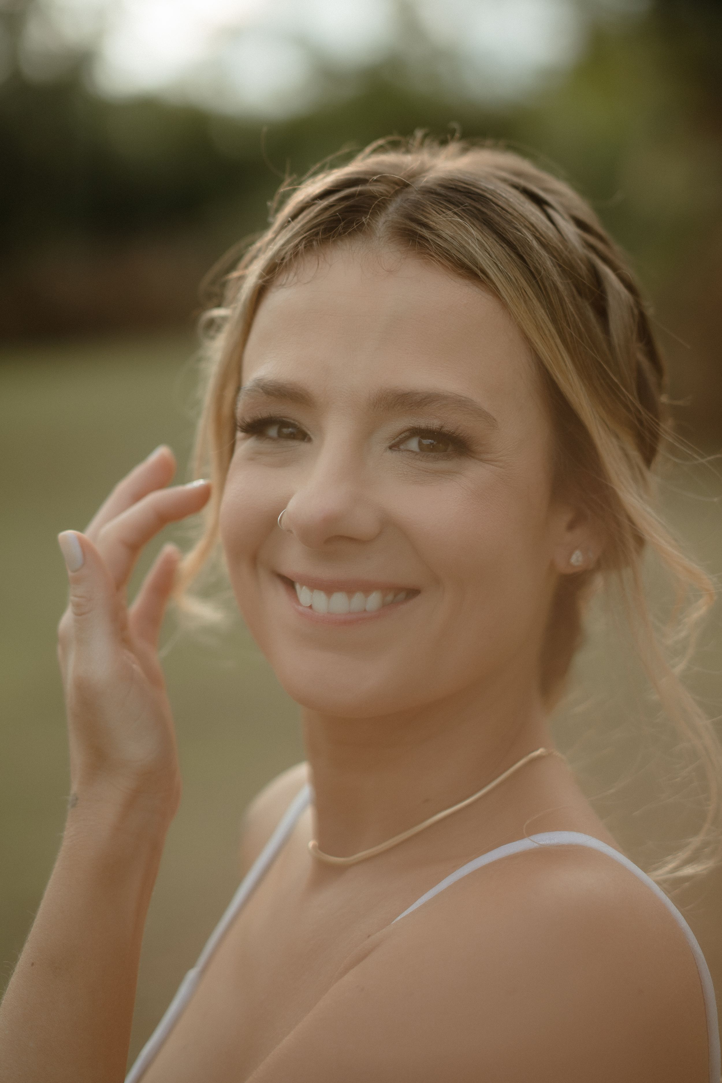 Elegant wedding portrait showing delicate jewelry and natural makeup.