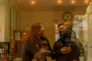 In-home family photography in Hamilton — cozy moment in a warmly lit kitchen featuring vintage details and real connection.