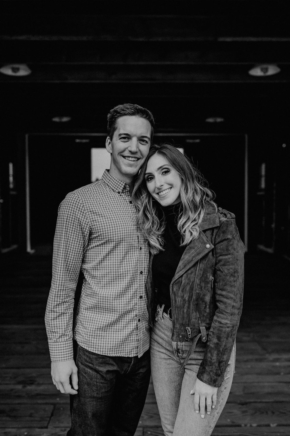 Black and white portrait of a couple smiling at Ancich Park in Gig Harbor, Washington.