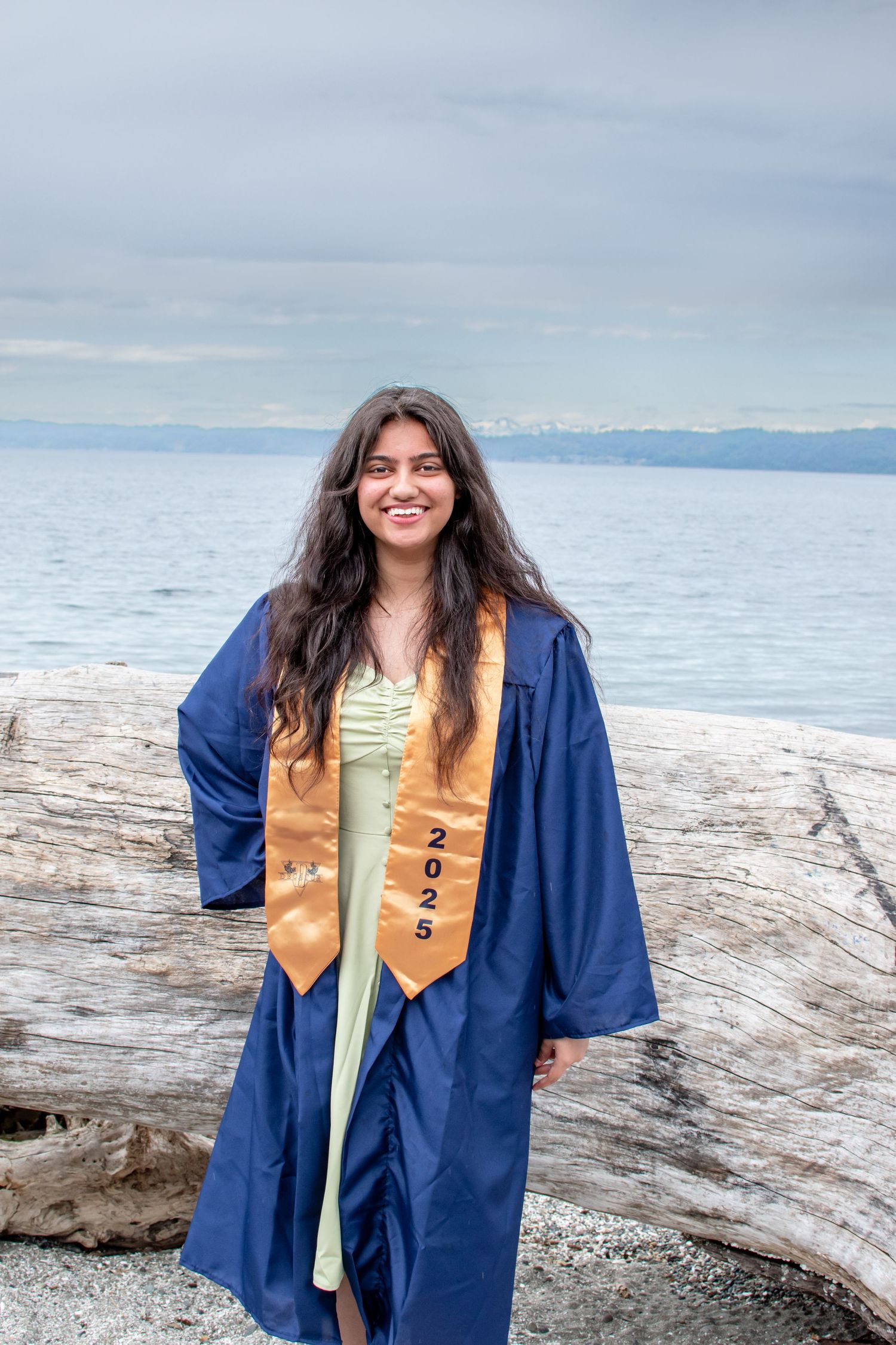 Senior graduation portrait by the water – cap and gown photo for Class of 2025 in Federal Way, WA.