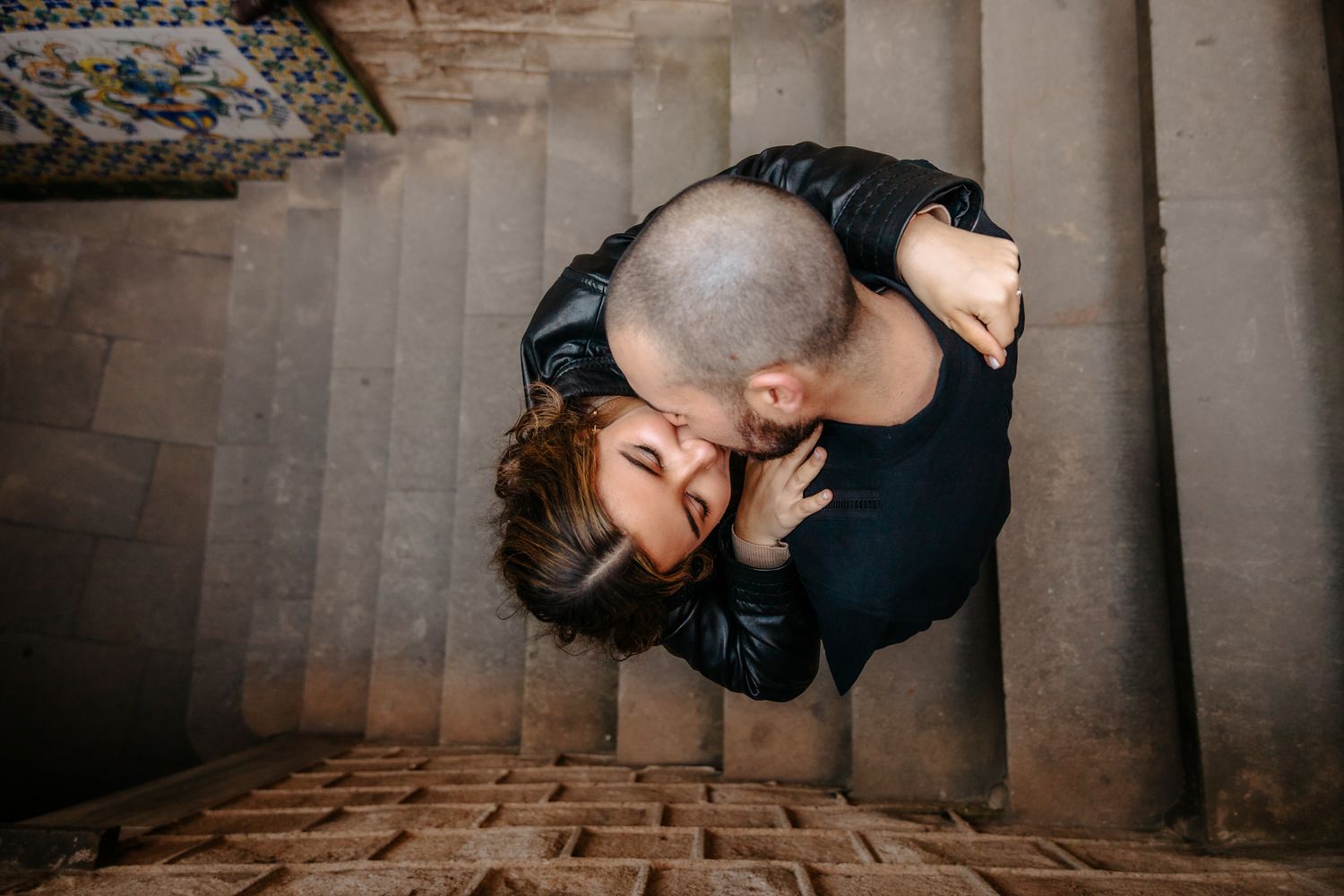 Tender moment as Jared kisses Angelina’s forehead under soft shadows.