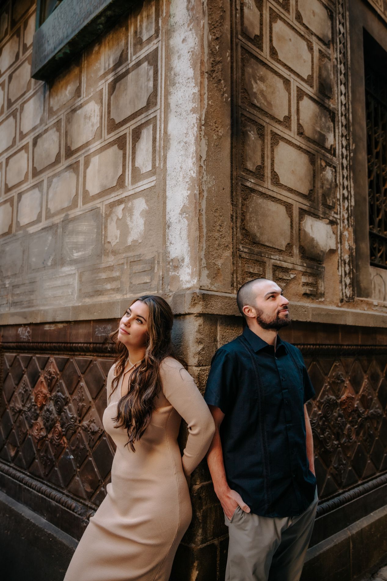 Wide-angle image of them walking through an archway in the old city.