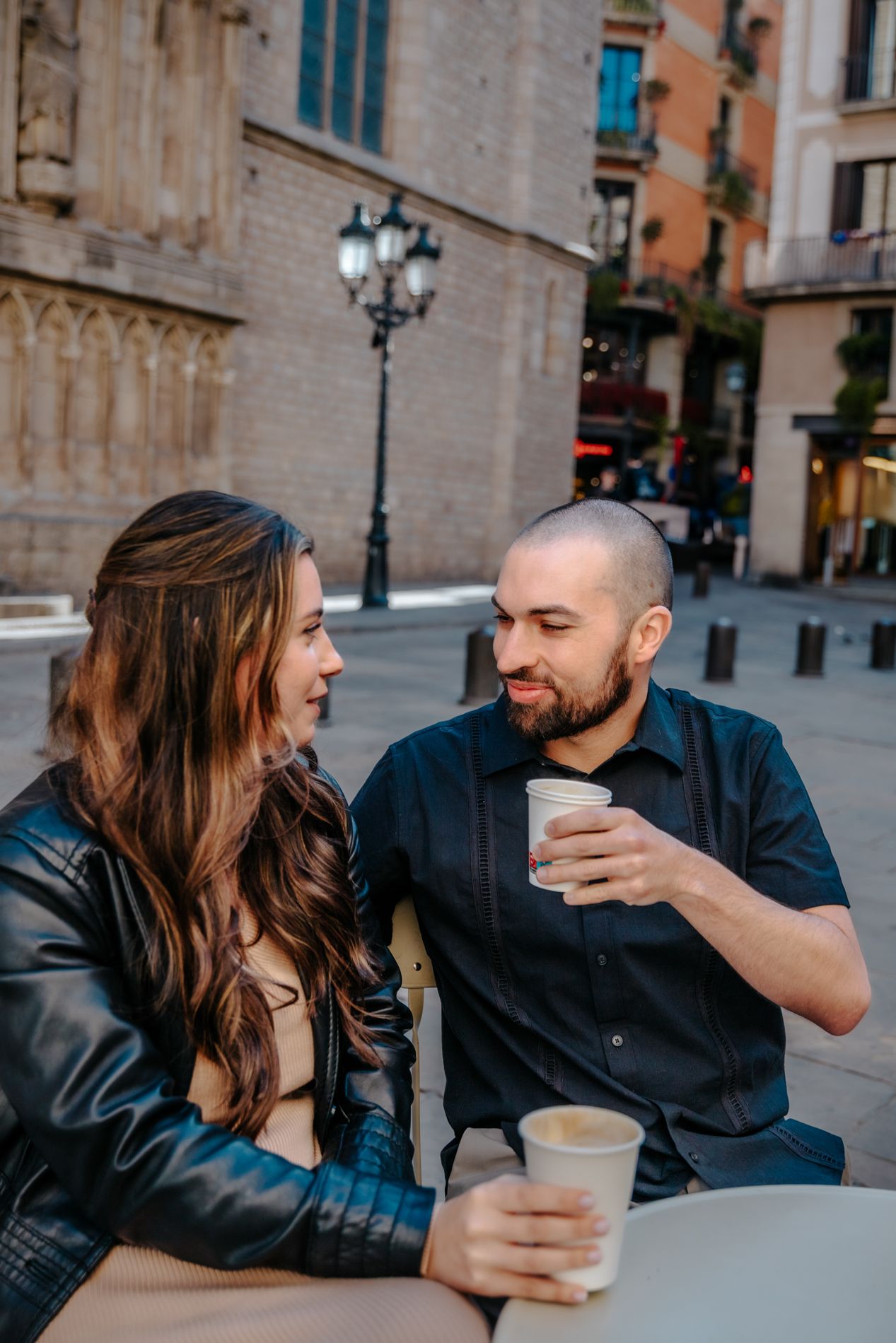 Frontal portrait of the couple with the historic cathedral steps behind them.