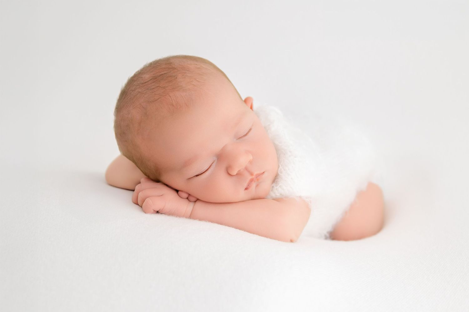 Three white photos show a sleeping newborn baby in different poses on neutral-toned backgrounds.