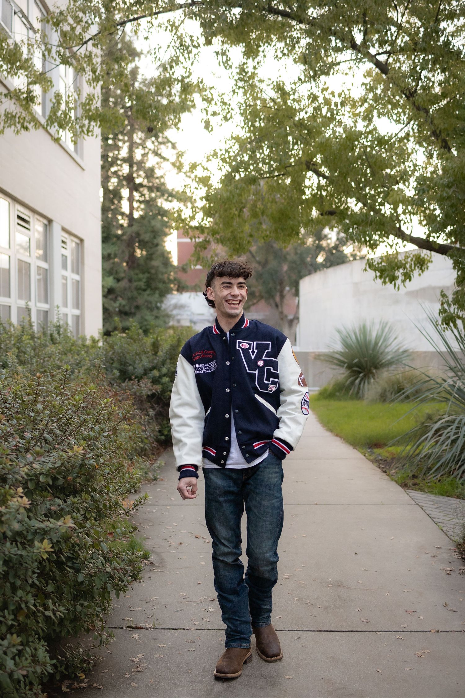 UC Davis senior portrait of student in letterman jacket