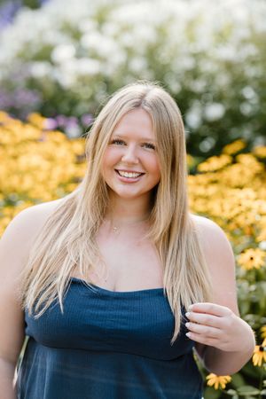 A series of portraits captured in a garden with yellow flowers and white blossoms in the background.