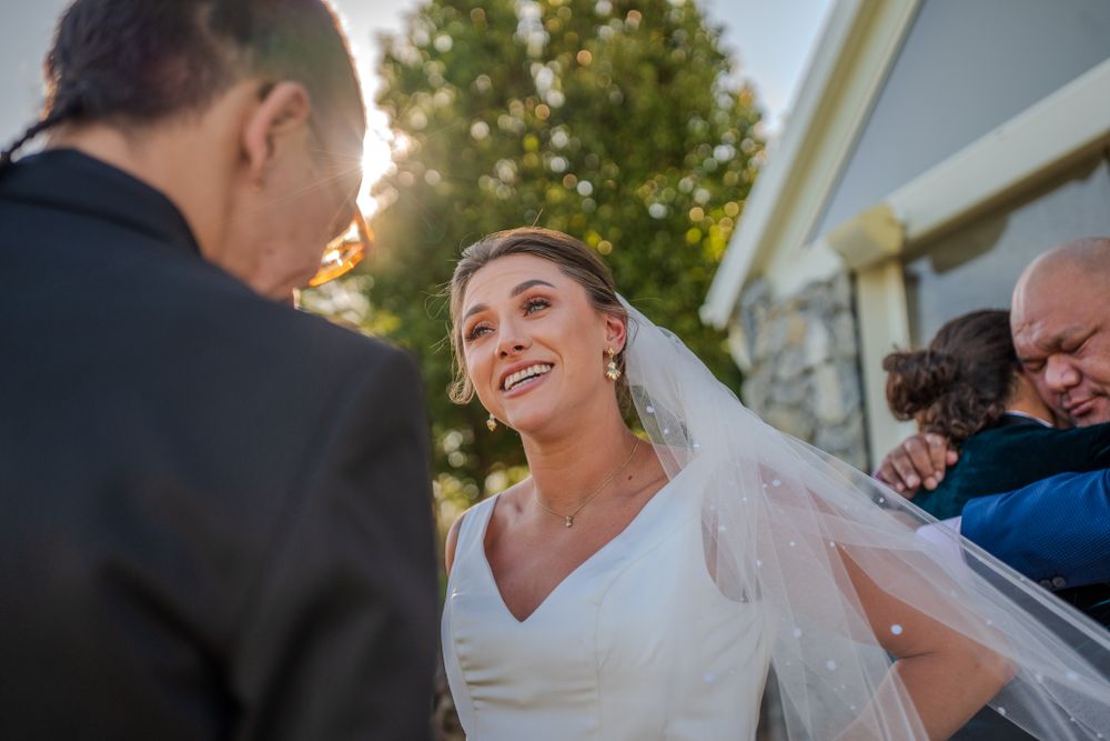 A candid wedding ceremony moment captured during golden hour.