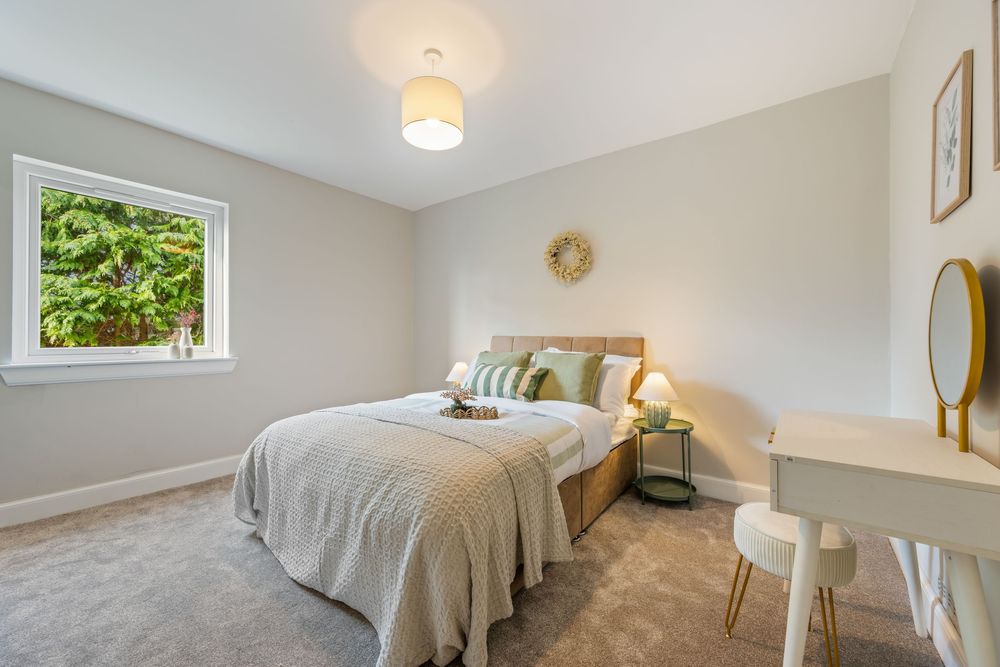 Modern bedroom interior with white walls, ceiling lights, and hardwood flooring in a bright minimalist style.