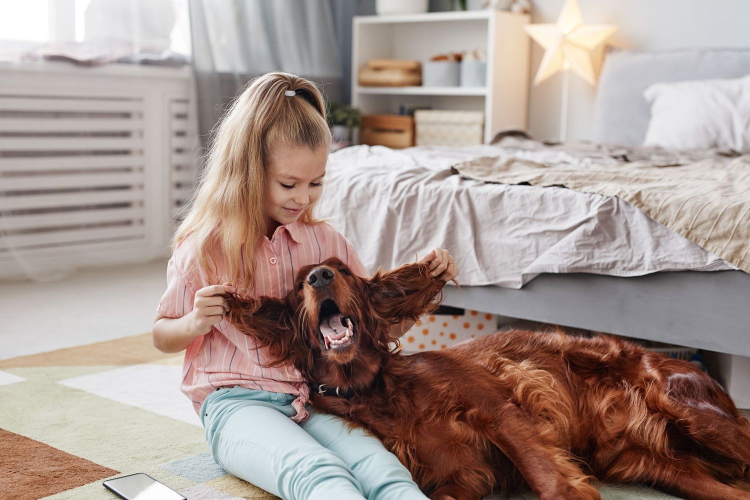 little girl playing with dog