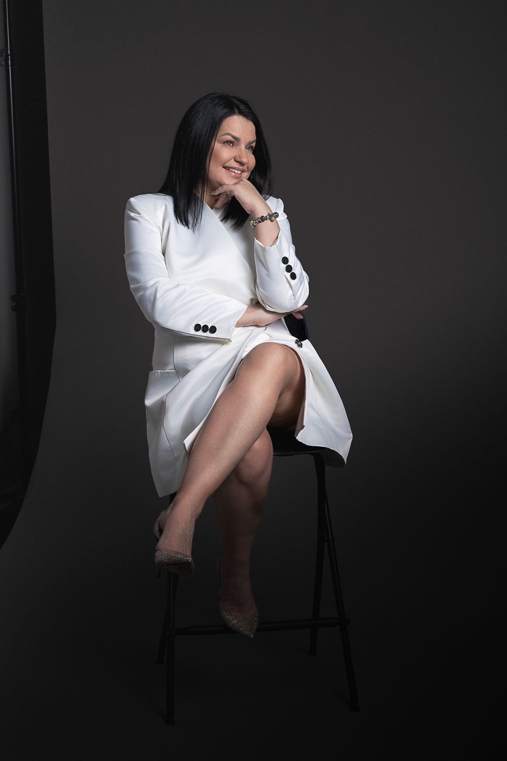 Minimalist portrait series in white button-down shirt against dark background.