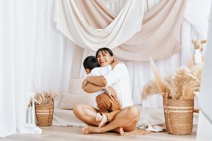 A collection of soft, minimalist maternity photos in white featuring tender moments and woven baskets as props.
