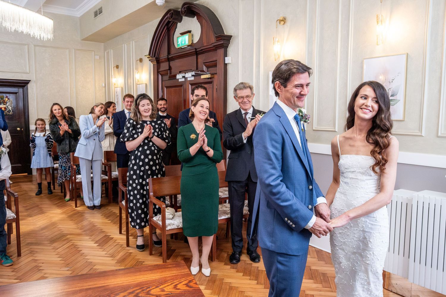 A bride and groom standing together and smiling on their wedding day.