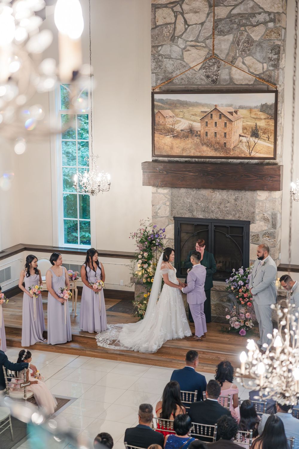 Bride and groom standing together in the chapel at the ancaster mill during their wedding ceremony in hamilton, ontario.